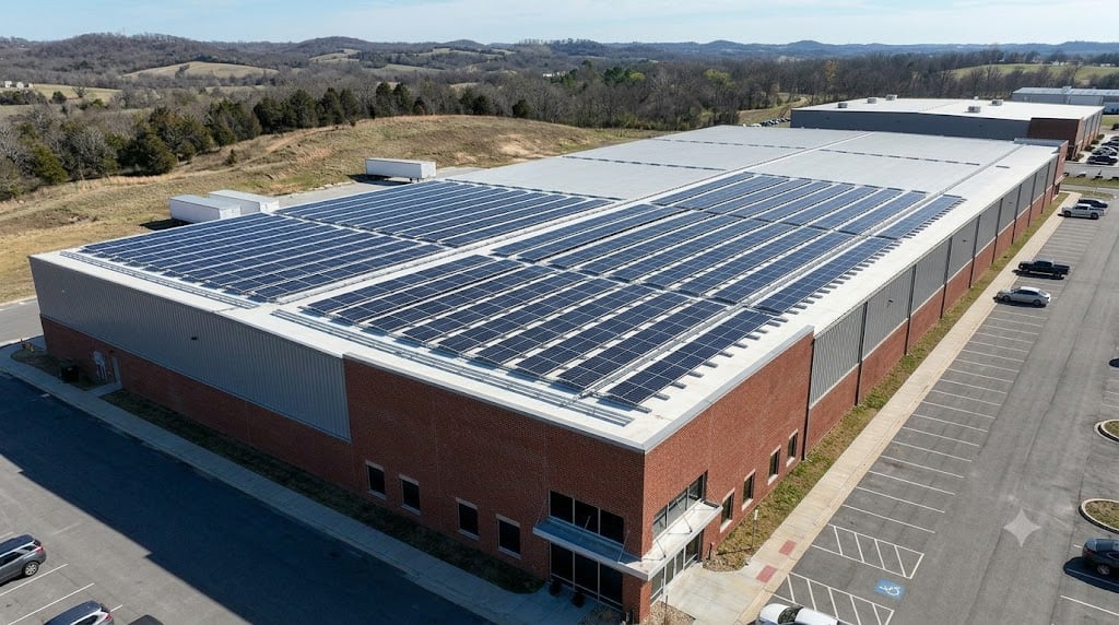 Aerial view of a Shinnova commercial rooftop solar array on a large warehouse